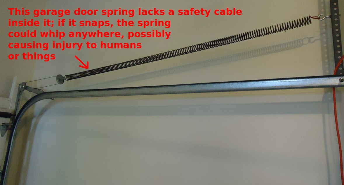 Broken garage door spring with safety cable